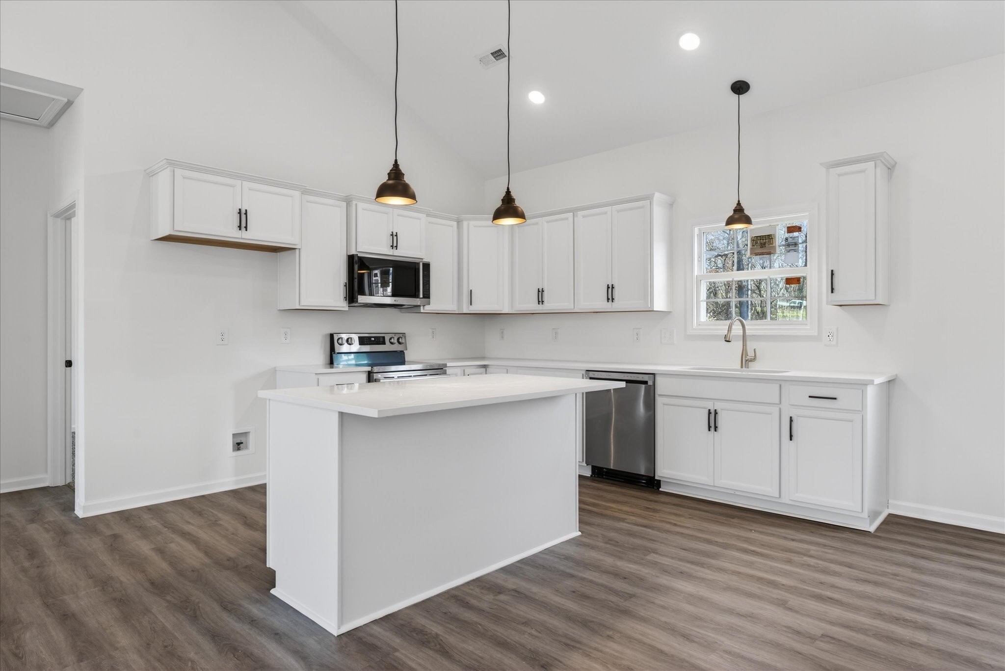 613 Hill Road Clarksville, TN 37040 - Photo 13 of 37 a kitchen with stainless steel appliances granite countertop a sink a stove a refrigerator and island with wooden floor