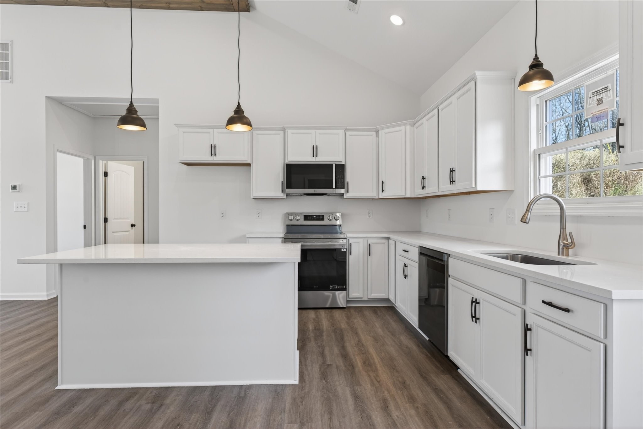 613 Hill Road Clarksville, TN 37040 - Photo 14 of 37 a kitchen with kitchen island white cabinets and black stainless steel appliances
