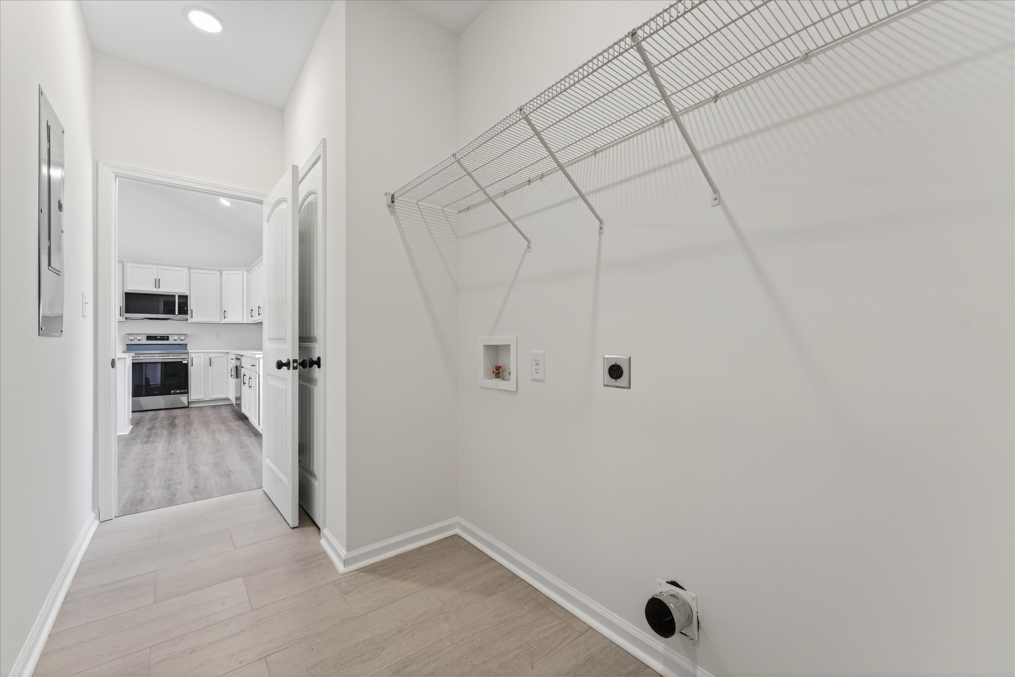 613 Hill Road Clarksville, TN 37040 - Photo 19 of 37 a view of a hallway with white walls and wooden floor