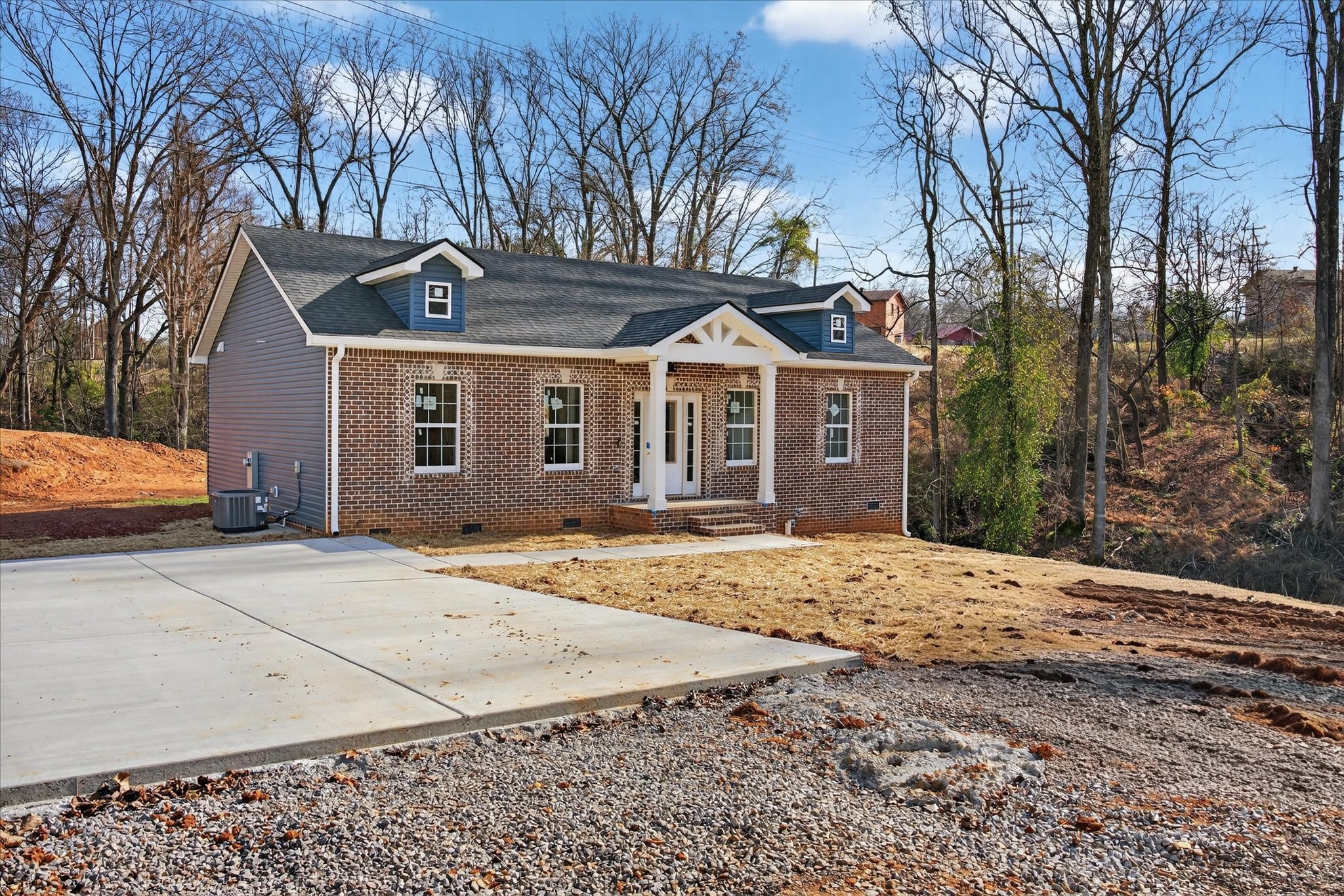 613 Hill Road Clarksville, TN 37040 - Photo 5 of 37 a front view of a house with a dirt yard and a garage
