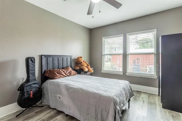 a bedroom with a bed next to a window