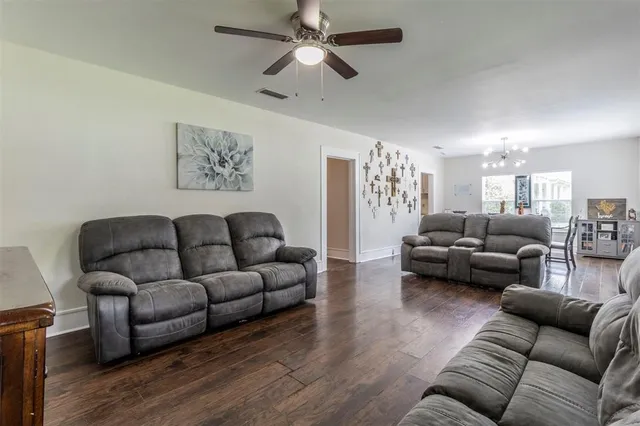 a living room with furniture and a ceiling fan