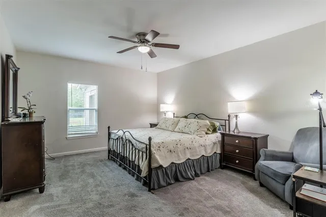 a bedroom with a bed a couch and dresser