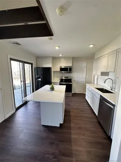 a kitchen with stainless steel appliances a refrigerator sink and cabinets