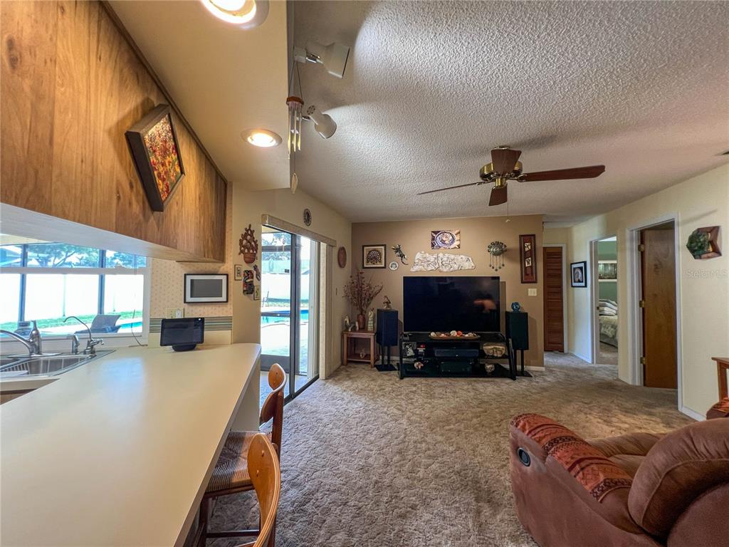 12156 98th Avenue North Seminole, FL 33772 - Photo 23 of 68 a living room with furniture and a flat screen tv
