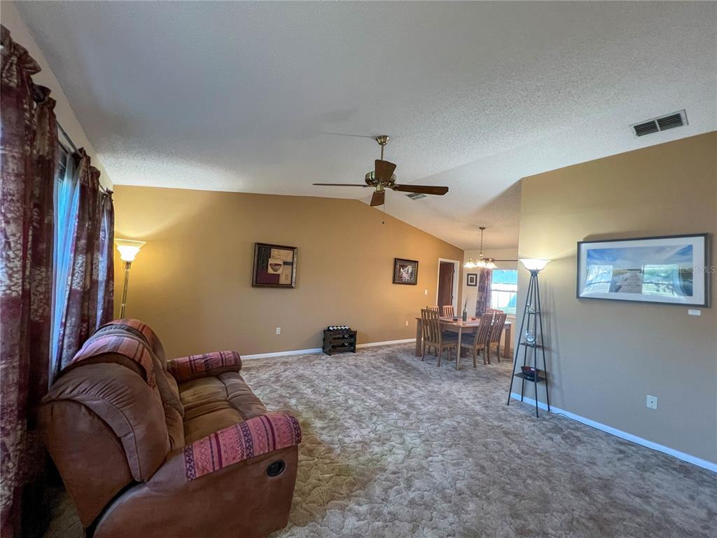 12156 98th Avenue North Seminole, FL 33772 - Photo 40 of 68 a living room with furniture and a flat screen tv