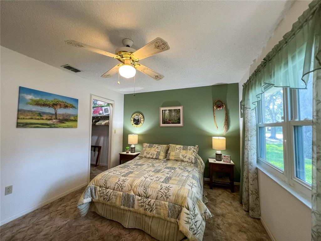 12156 98th Avenue North Seminole, FL 33772 - Photo 48 of 68 a bedroom with a bed and a chandelier