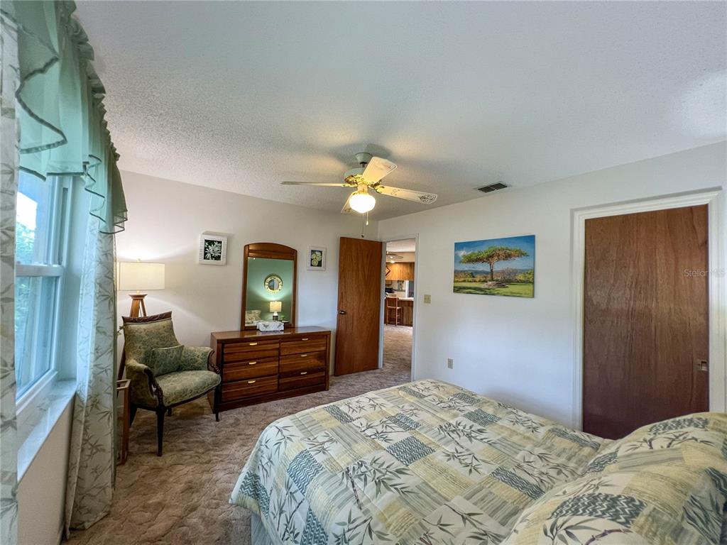 12156 98th Avenue North Seminole, FL 33772 - Photo 50 of 68 a bedroom with a bed and a large mirror