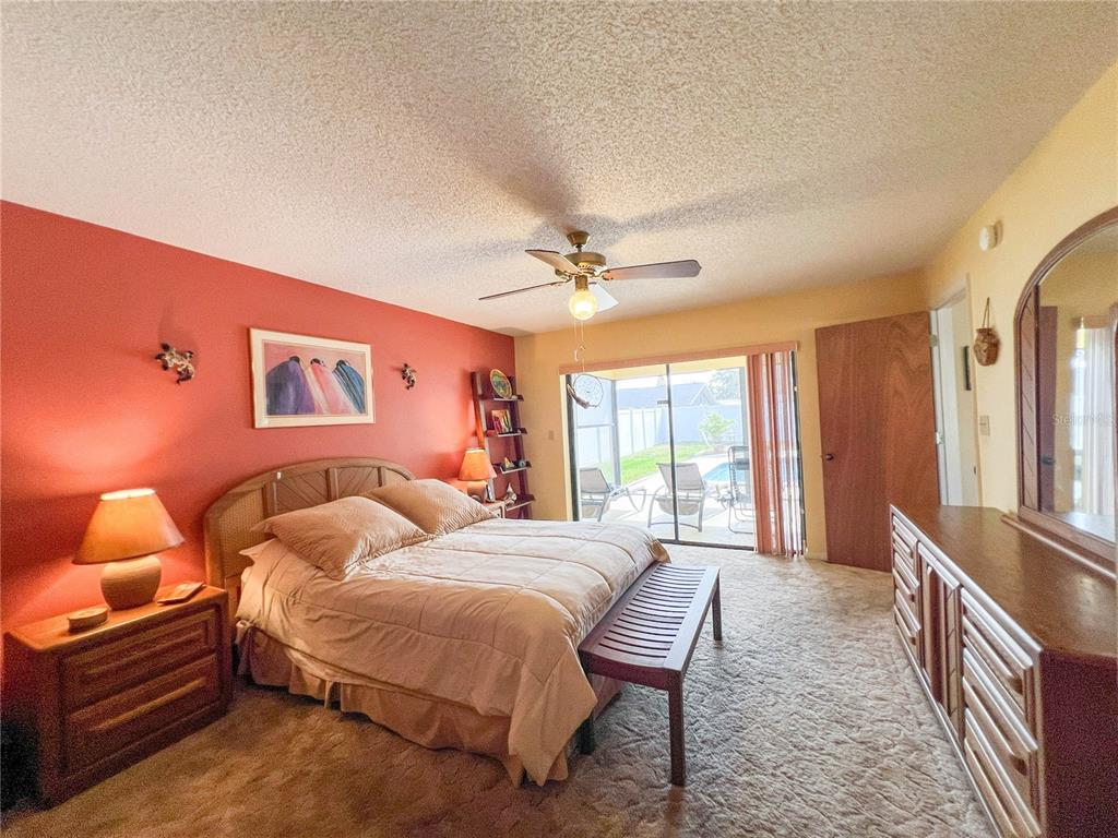 12156 98th Avenue North Seminole, FL 33772 - Photo 9 of 68 a bedroom with a bed and a chandelier