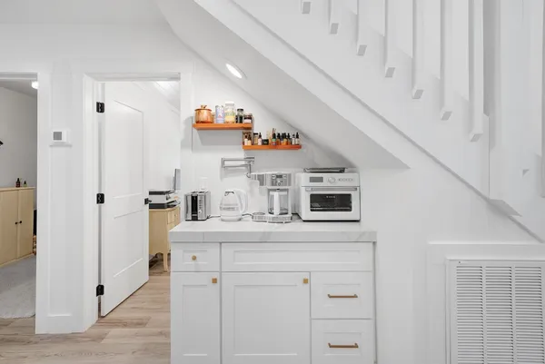 a kitchen with cabinets and window