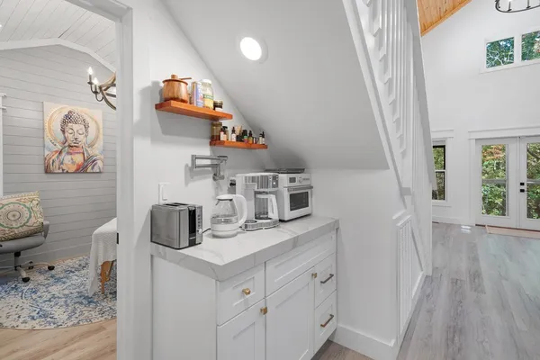 a room with a baby crib furniture and wooden floor
