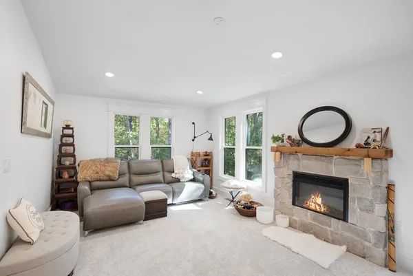 a living room with furniture a window and a fireplace