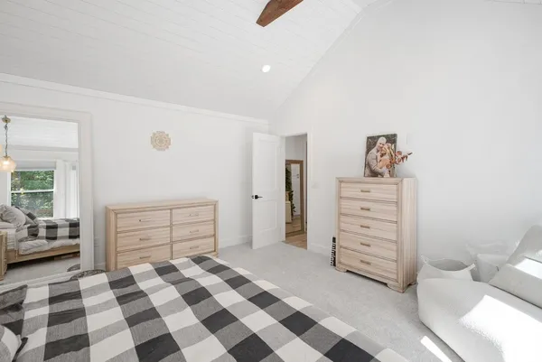 a room with a walk in closet and white cabinet