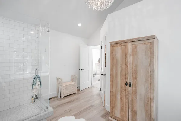 a spacious bathroom with a shower and a sink