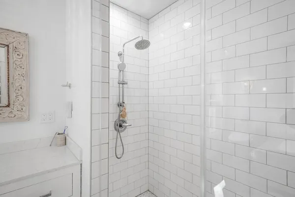 a bathroom with a shower and a sink