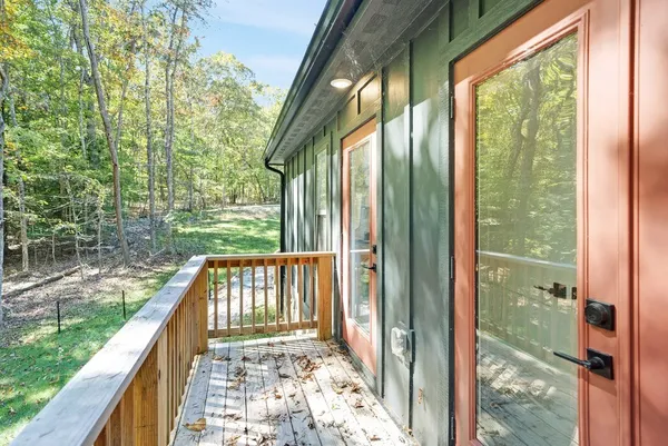 a view of a balcony with a yard