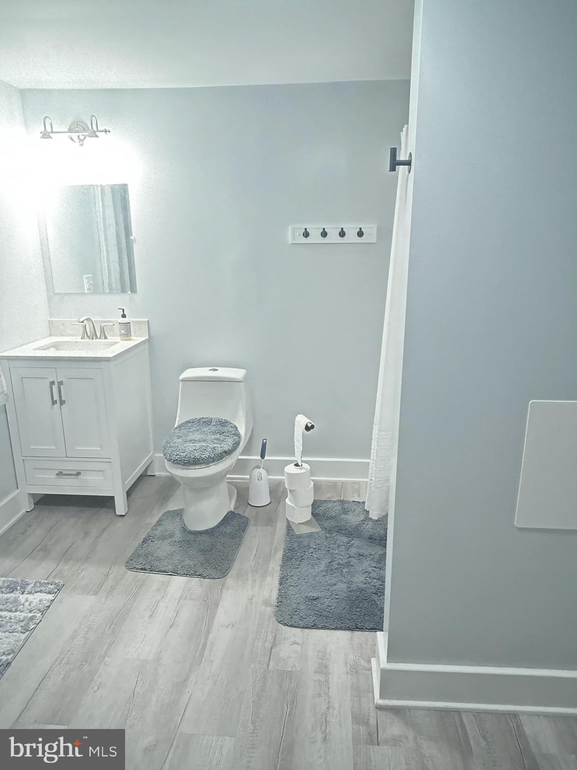 89 Second Street Keyser, WV 26726 - Photo 16 of 37 a bathroom with a toilet a sink and mirror