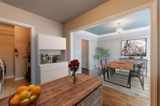 a kitchen with stainless steel appliances wooden floor and a refrigerator