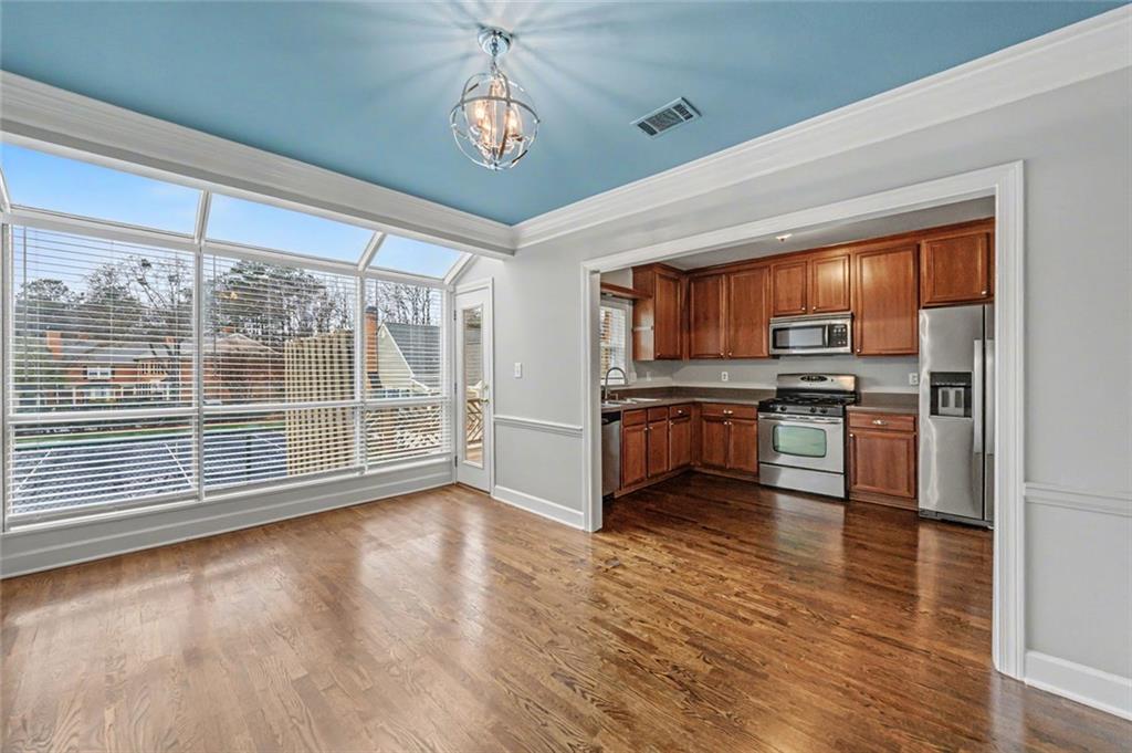 125 Mt Vernon Circle Atlanta, GA 30338 - Photo 15 of 62 a kitchen with stainless steel appliances wooden floor and a refrigerator
