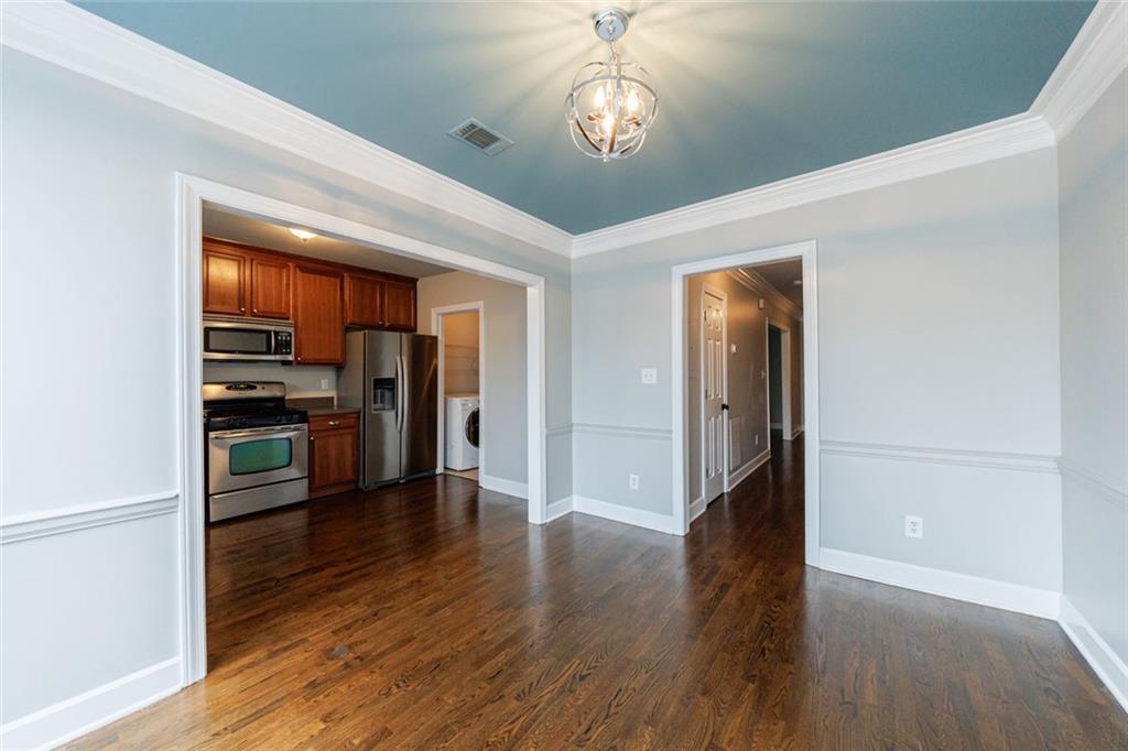 125 Mt Vernon Circle Atlanta, GA 30338 - Photo 18 of 62 a view of a hallway with wooden floor cabinets and a kitchen