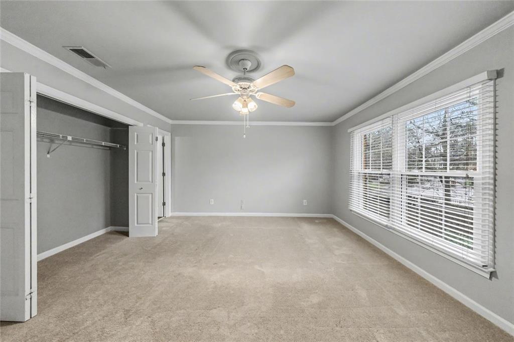 125 Mt Vernon Circle Atlanta, GA 30338 - Photo 25 of 62 an empty room with chandelier fan and windows