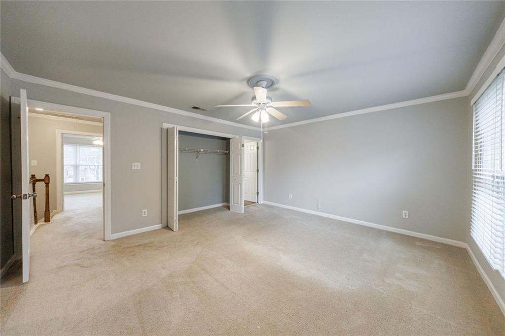 125 Mt Vernon Circle Atlanta, GA 30338 - Photo 26 of 62 an empty room with windows and a chandelier fan