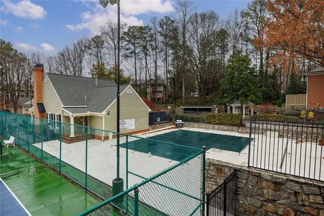 an empty room with wooden floor fireplace and windows