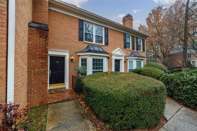 a kitchen with stainless steel appliances granite countertop a sink a stove a microwave oven and cabinets