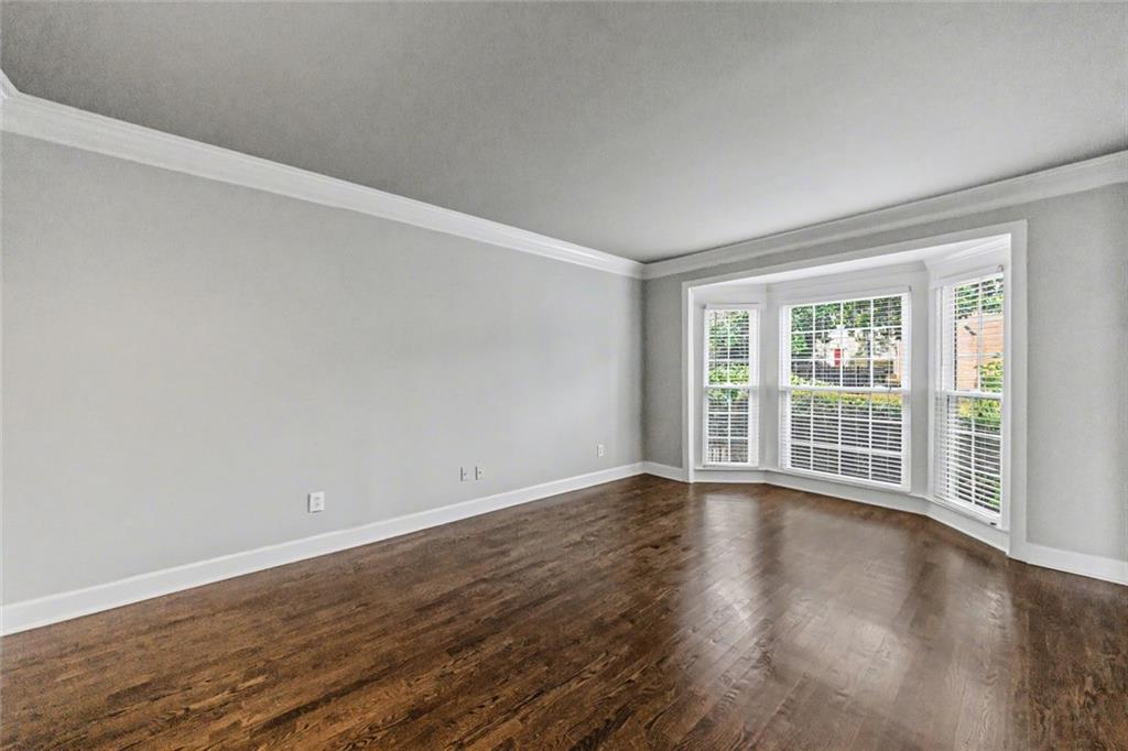 125 Mt Vernon Circle Atlanta, GA 30338 - Photo 4 of 62 a view of an empty room with wooden floor and a window