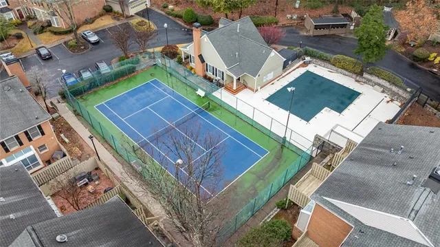a view of a swimming pool with a patio and a yard