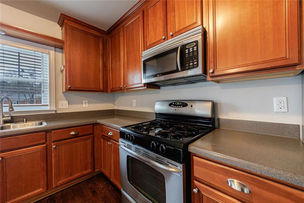 125 Mt Vernon Circle Atlanta, GA 30338 - Photo 51 of 62 a kitchen with stainless steel appliances granite countertop a sink a stove a microwave oven and cabinets