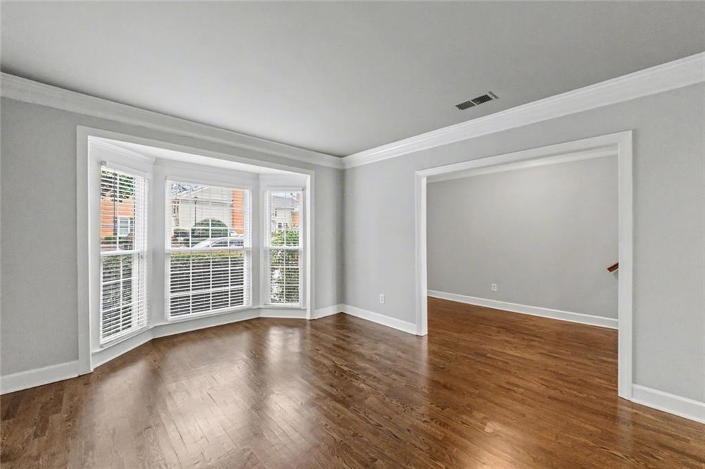 125 Mt Vernon Circle Atlanta, GA 30338 - Photo 8 of 62 a view of an empty room with wooden floor and a window