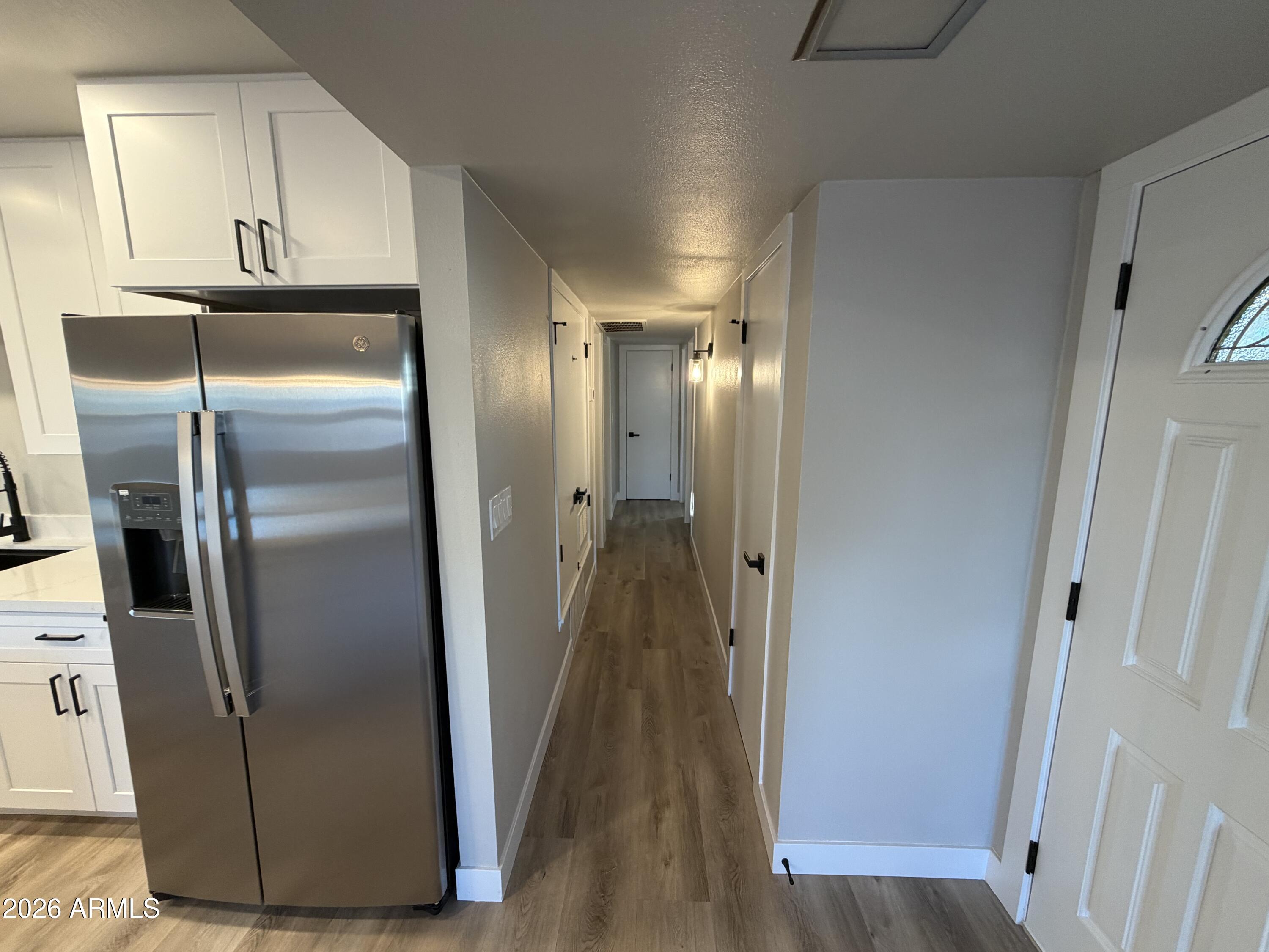 5420 North Granite Reef Road Scottsdale, AZ 85250 - Photo 5 of 30 a view of a refrigerator in kitchen and wooden floor