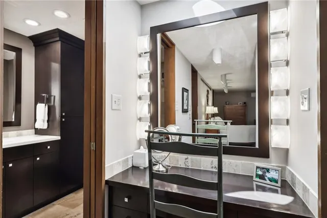 a bathroom with a sink vanity and mirror