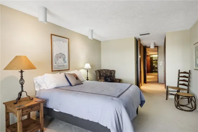 a bedroom with a bed and a lamp on table