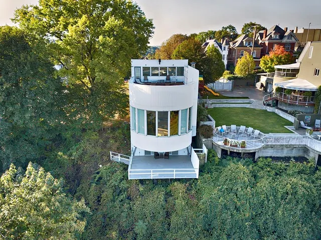an aerial view of a house with swimming pool garden and patio