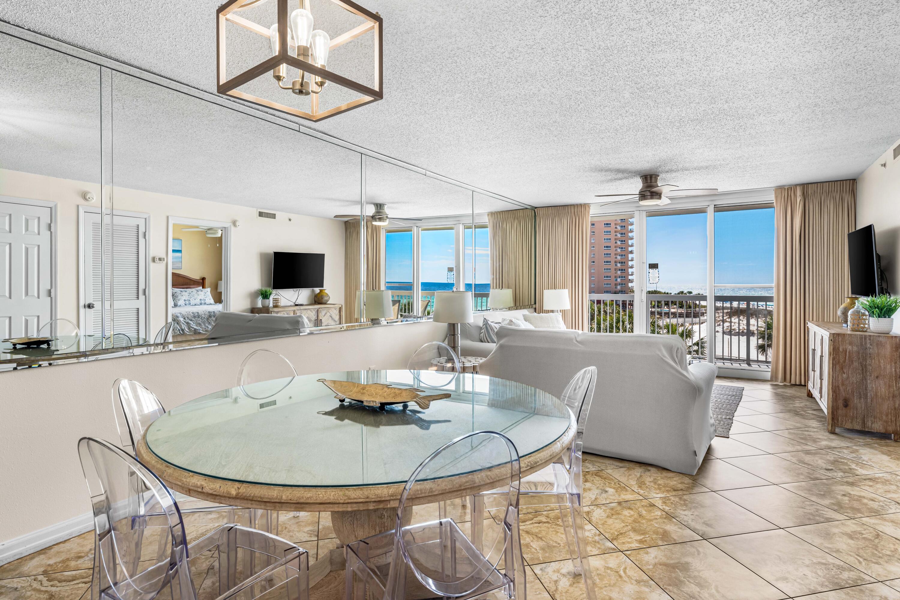 1002 Highway 98, Unit 415 Destin, FL 32541 - Photo 12 of 31 a living room with couches a dining table and kitchen view