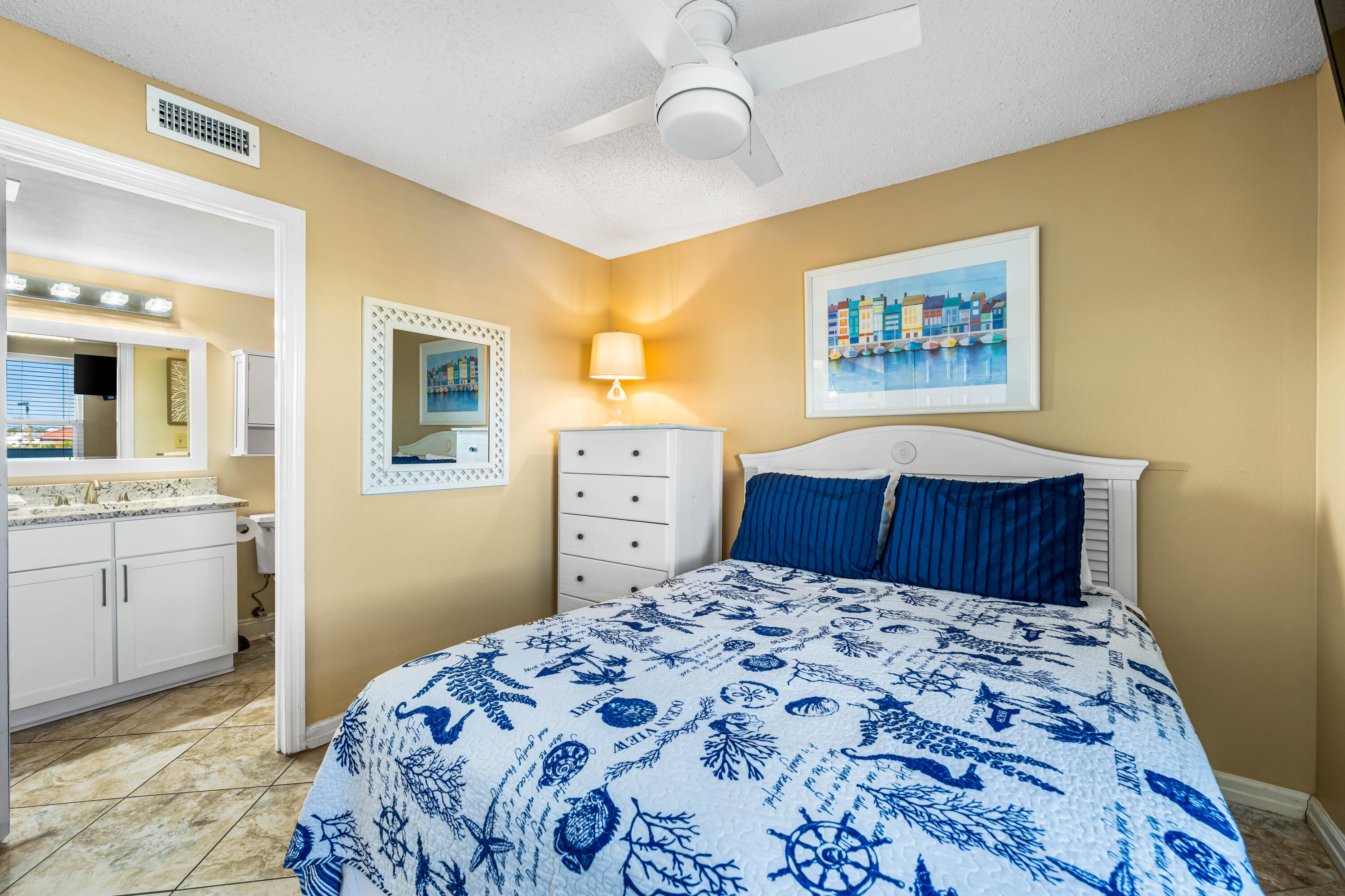 1002 Highway 98, Unit 415 Destin, FL 32541 - Photo 13 of 31 a bedroom with a bed and a dresser in it
