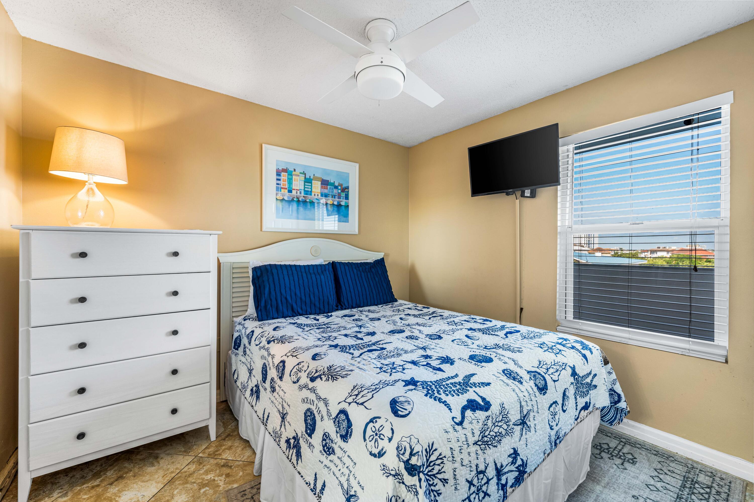 1002 Highway 98, Unit 415 Destin, FL 32541 - Photo 14 of 31 a bedroom with a bed and a flat screen tv