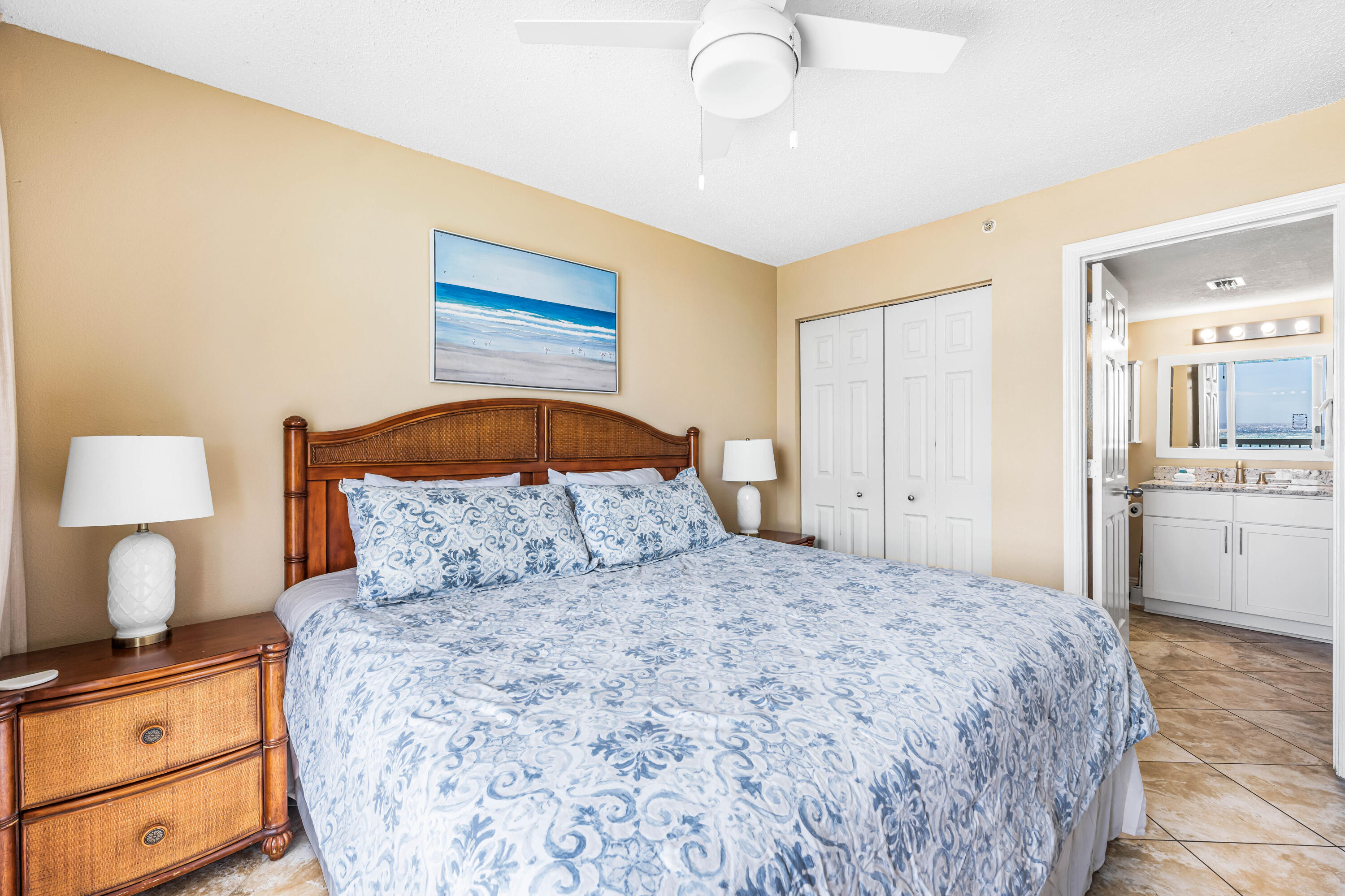 1002 Highway 98, Unit 415 Destin, FL 32541 - Photo 8 of 31 a bedroom with a bed and a lamp