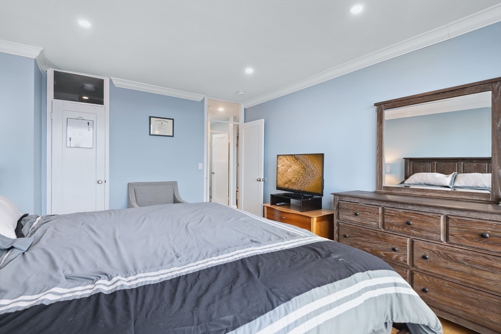 85 East India Row, Unit 16H Boston, MA 02110 - Photo 13 of 20 a bedroom with a bed and a flat screen tv