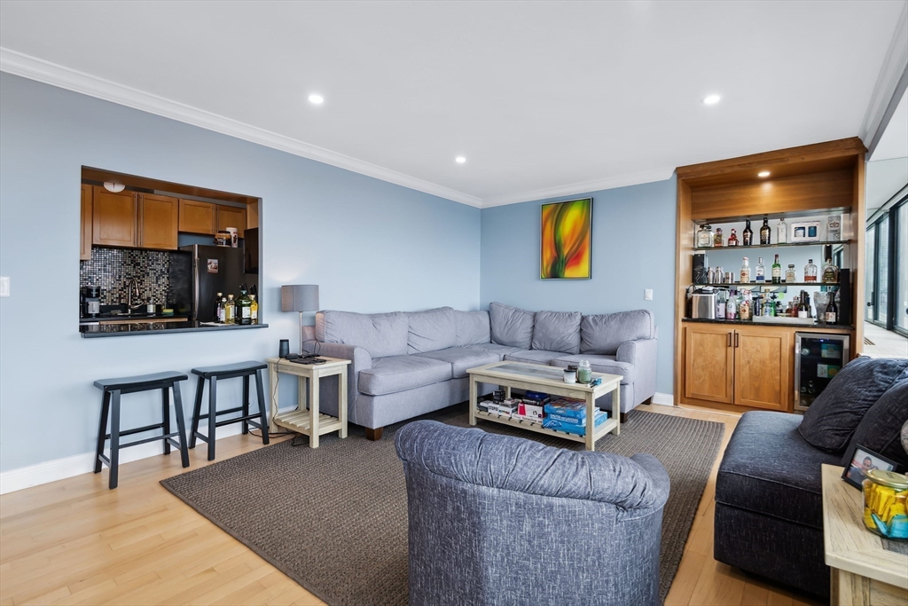 85 East India Row, Unit 16H Boston, MA 02110 - Photo 6 of 20 a living room with furniture and a flat screen tv