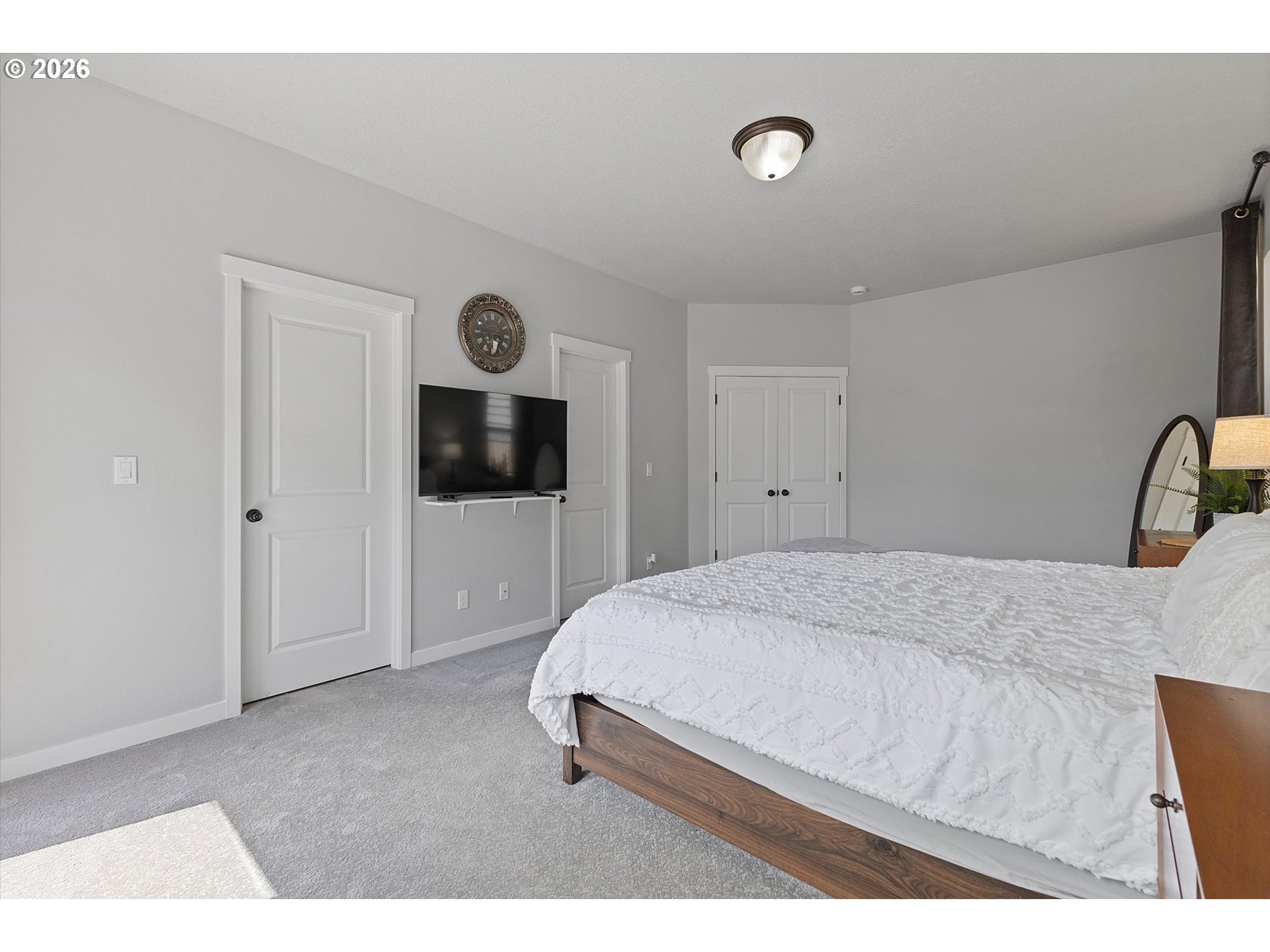 830 Southeast Darrow Road Estacada, OR 97023 - Photo 23 of 45 a bedroom with a bed and a flat screen tv