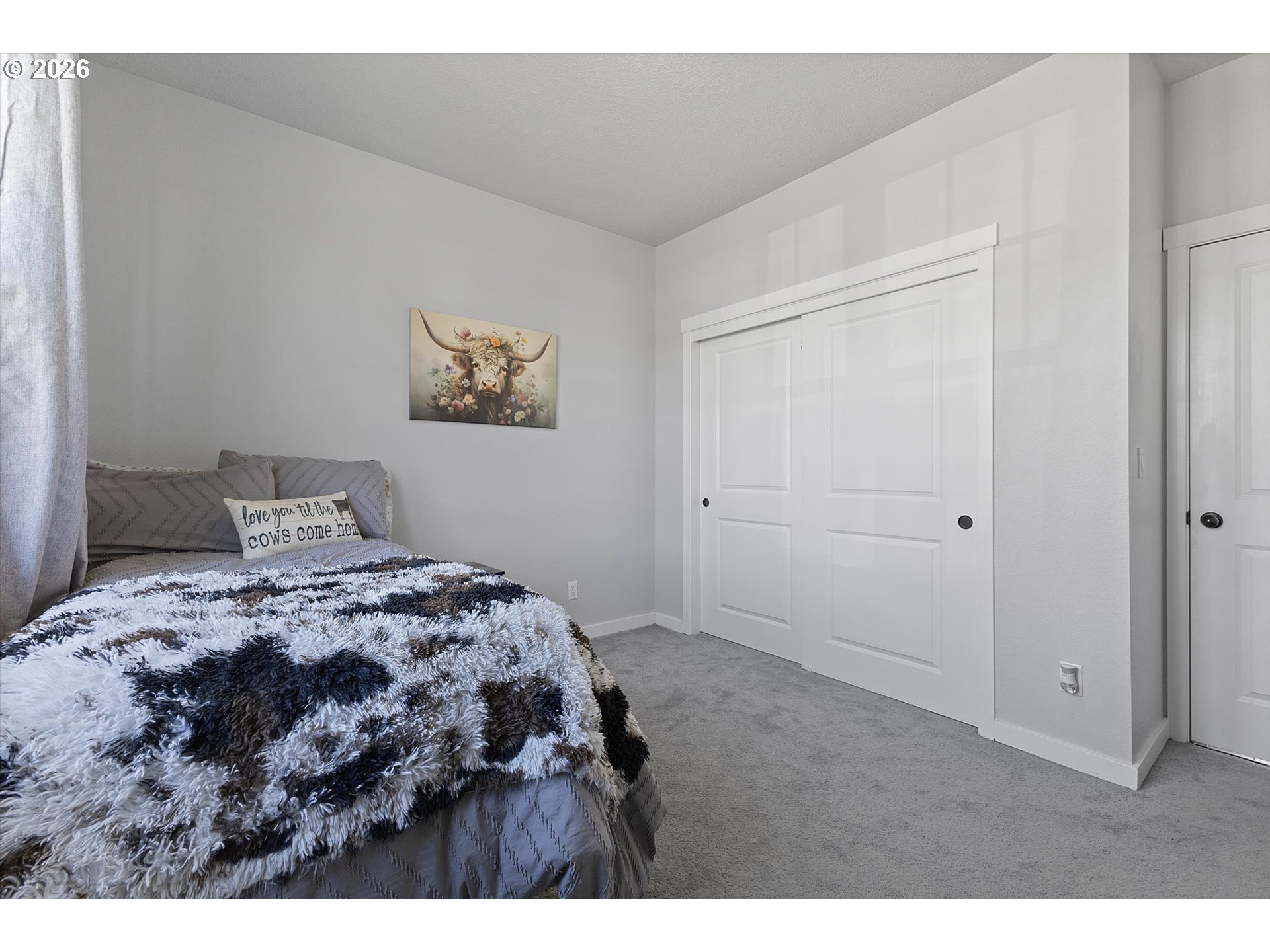 830 Southeast Darrow Road Estacada, OR 97023 - Photo 31 of 45 a bedroom with a bed and a painting on the wall