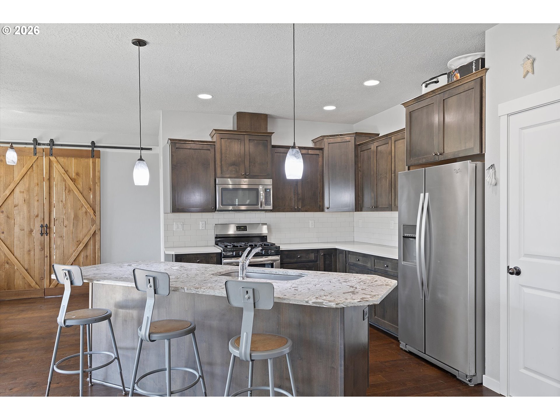 830 Southeast Darrow Road Estacada, OR 97023 - Photo 7 of 45 a kitchen with stainless steel appliances kitchen island a chandelier