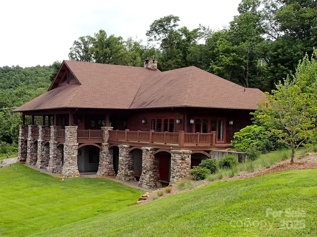 a view of a house with a yard balcony and furniture