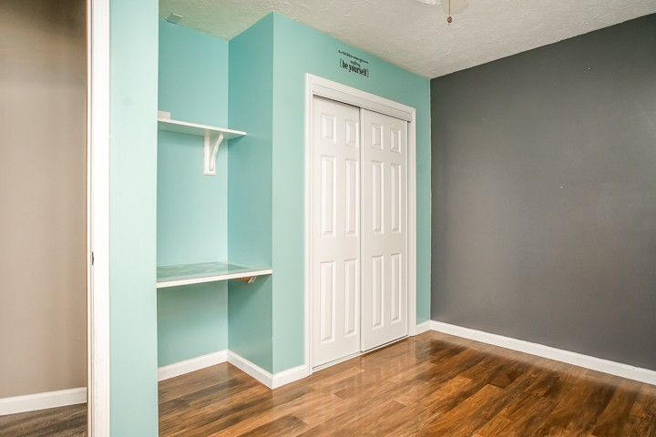 391 Oakley Allons Road Allons, TN 38541 - Photo 19 of 35 an empty room with wooden floor closet and windows