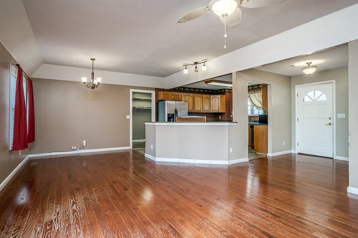 391 Oakley Allons Road Allons, TN 38541 - Photo 3 of 35 an empty room with wooden floor and kitchen view