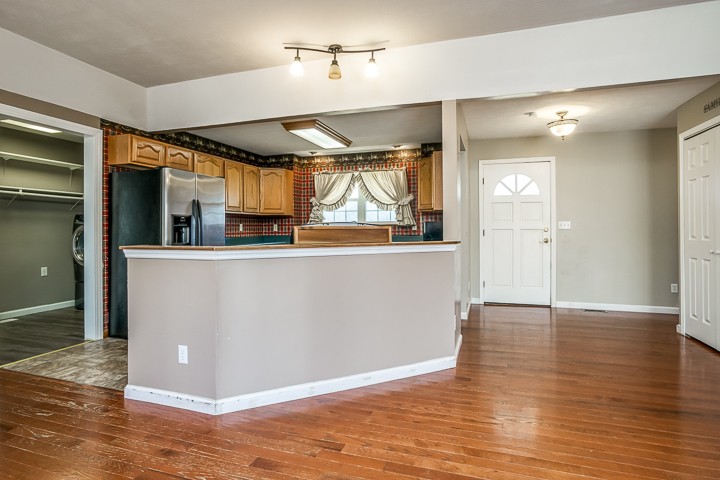 391 Oakley Allons Road Allons, TN 38541 - Photo 4 of 35 a view of a kitchen with a fridge and wooden floor