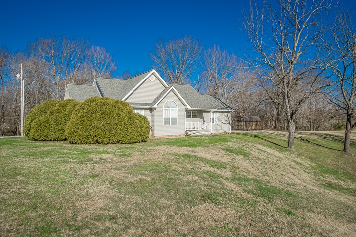 391 Oakley Allons Road Allons, TN 38541 - Photo 32 of 35 a view of a white house with a big yard and large trees